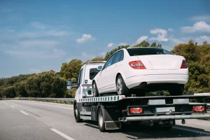 car being transported on the top of flatbed tow truck